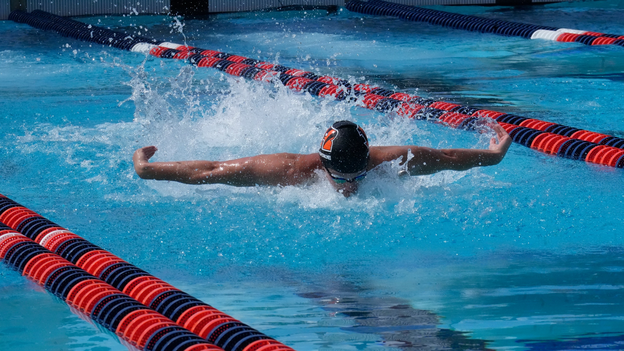 Male swimmer doing breaststroke in the water