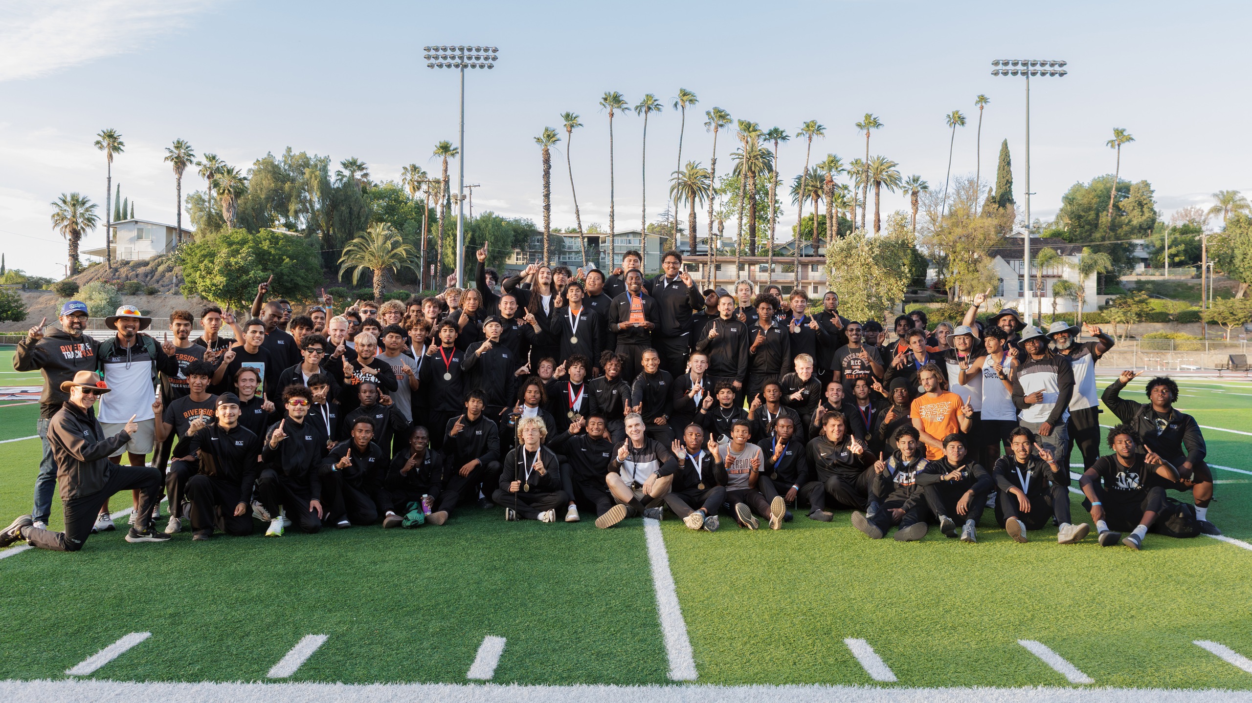 The RCC men's track and field team celebrates winning the OEC championship